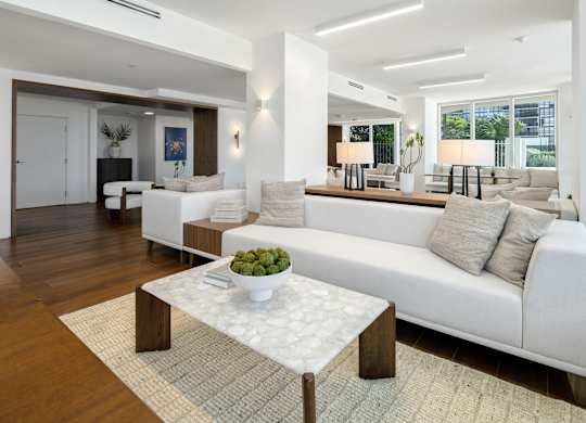 Contemporary living room with white sofa and marble coffee table at The Hamilton Apartments, Miami
