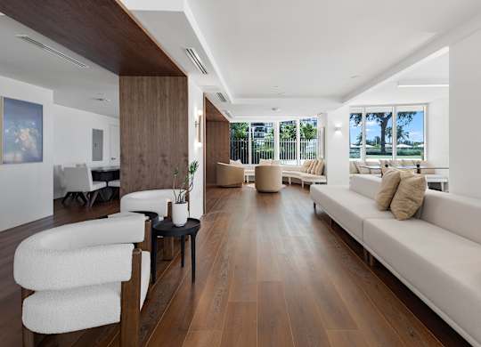 Open living space with hardwood floors and water views at The Hamilton Apartments, Florida