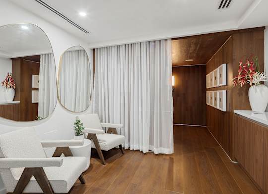 Spa relaxation room with modern chairs and mirrors at The Hamilton Apartments, Miami, FL