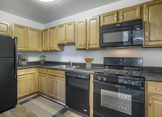 Kitchen with Black Refrigerator at The Manor/The Manor East Apartments, Leesburg, VA, 20176