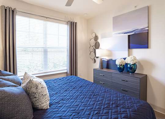 Bedroom with window at The Rosemary Apartments, Humble, Texas
