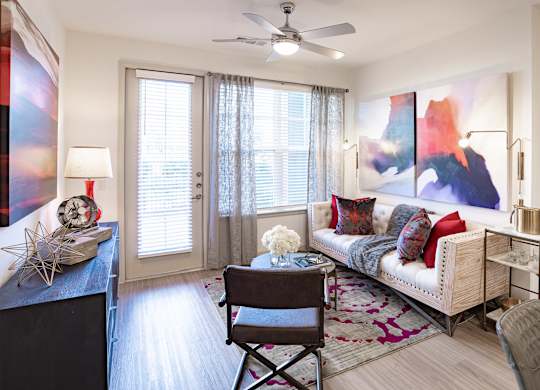 Living room area with couch and table at The Rosemary Apartments, Humble, TX