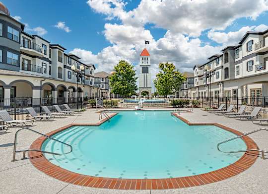 our apartments have a large pool with a church tower in the background at Villaggio Apartments, Louisiana, 71111