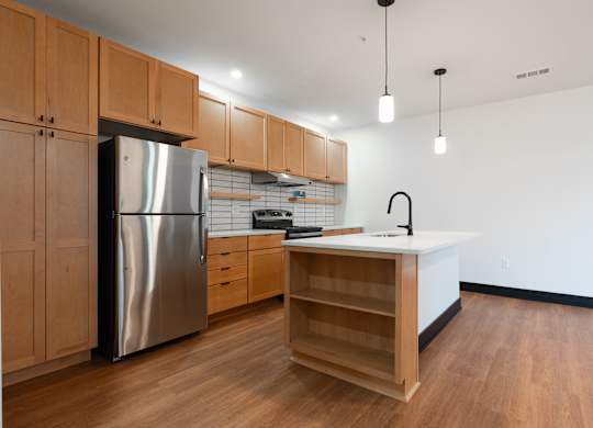 Kitchen with stainless steel refrigerator at The Yard Apartments, Louisville, 40202