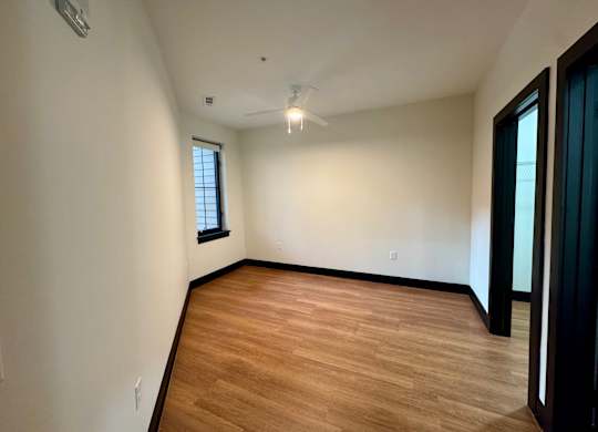 Room with wooden flooring and a ceiling fan at The Yard Apartments, Louisville, KY, 40202