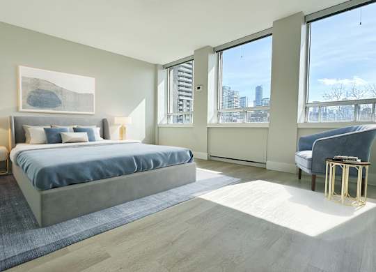a bedroom with a large bed and a large window