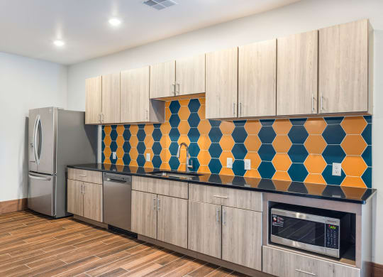 a kitchen with wooden cabinets and a stainless steel refrigeratorat Northern Lights a Lifestyle-Driven Community, West Fargo, ND, 58078
