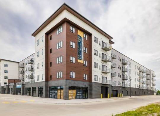 a large apartment building with a street in front of itat Northern Lights a Lifestyle-Driven Community, West Fargo, ND