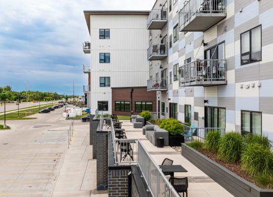 a view of the street from a balcony of a large white buildingat Northern Lights a Lifestyle-Driven Community, West Fargo, 58078