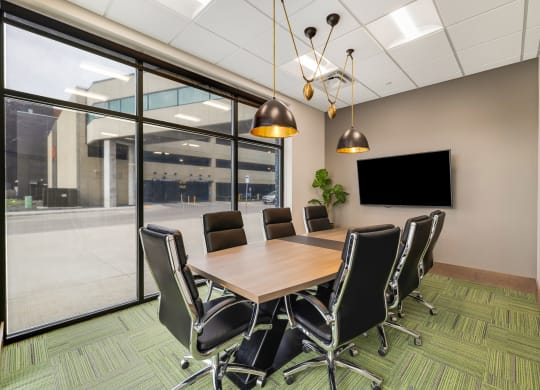 a conference room with a table and chairs and a tvat Northern Lights a Lifestyle-Driven Community, West Fargo, 58078