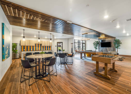 a game room with a pool table and a barat Northern Lights a Lifestyle-Driven Community, West Fargo, North Dakota