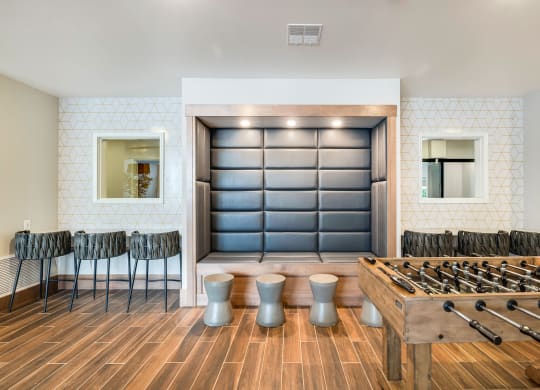 a game room with a foosball table and chairsat Northern Lights a Lifestyle-Driven Community, West Fargo, ND, 58078