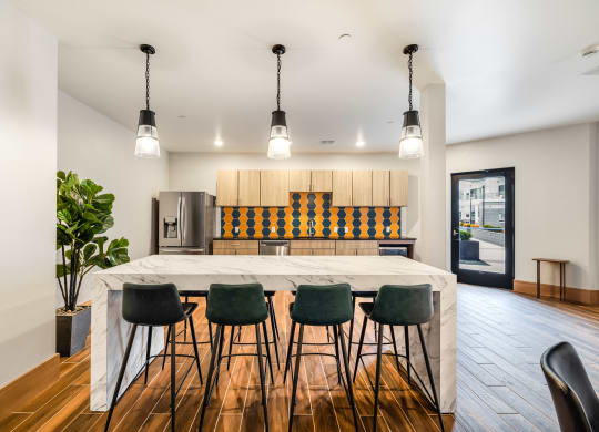 a kitchen with a large island and bar chairs at Northern Lights a Lifestyle-Driven Community, North Dakota