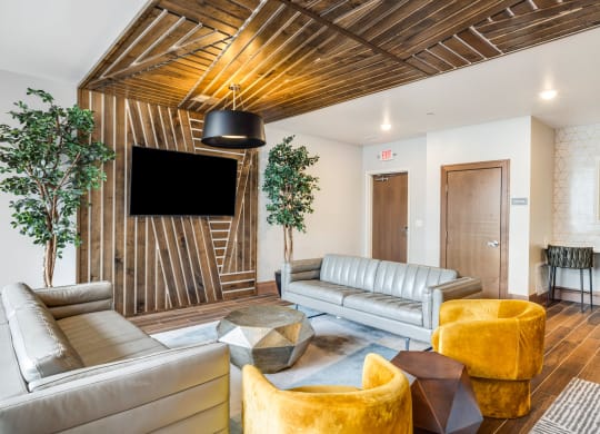 a living room with couches and chairs and a tvat Northern Lights a Lifestyle-Driven Community, West Fargo, ND