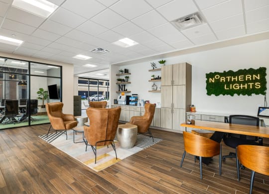 a lounge area with chairs and a table in a break room at Northern Lights a Lifestyle-Driven Community, West Fargo, ND