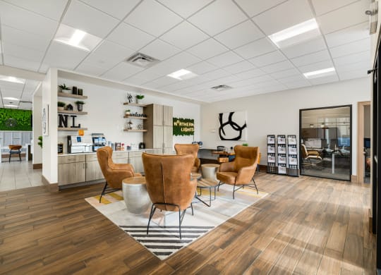 the waiting room of a salon with chairs and a table at Northern Lights a Lifestyle-Driven Community, West Fargo, ND