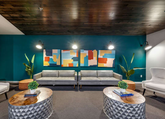 a lobby with couches and tables and a colorful wallat Northern Lights a Lifestyle-Driven Community, West Fargo, 58078