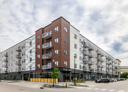 a large apartment building on the corner of a city street at Northern Lights a Lifestyle-Driven Community, West Fargo, ND