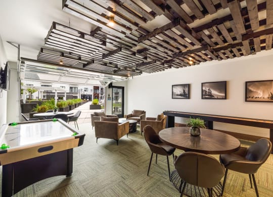 a room with tables and chairs and a pool tableat Northern Lights a Lifestyle-Driven Community, West Fargo, ND