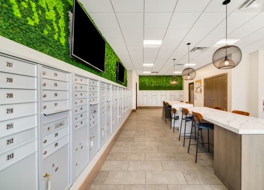 a long hallway with lockers and a table with chairs at Northern Lights a Lifestyle-Driven Community, West Fargo, ND, 58078