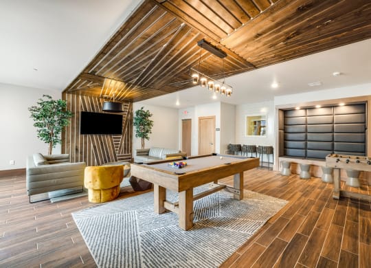a game room with a pool table and a televisionat Northern Lights a Lifestyle-Driven Community, West Fargo, ND
