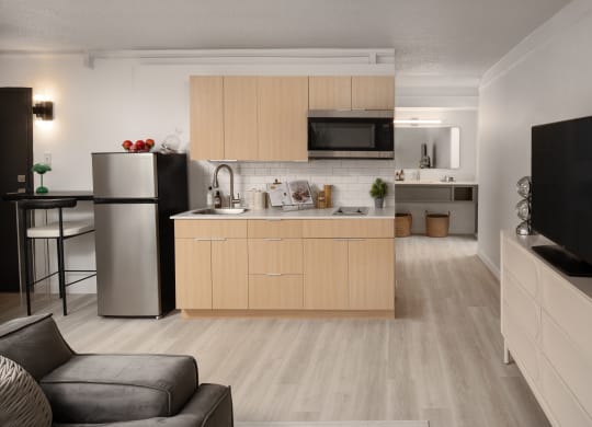 a kitchen and living room with a refrigerator and a sink at Vision on Lombard, Baltimore, MD 21201