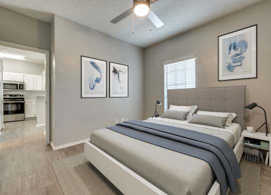 a bedroom with a bed and a ceiling fan at Foxborough Apartments, Irving, TX, Texas, 75061