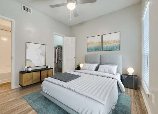 a bedroom with a large bed and a ceiling fan at Foxborough Apartments, Irving, TX, Texas, 75061