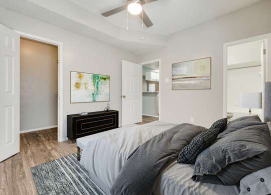 a bedroom with a large bed and a ceiling fan at Foxborough Apartments, Irving, TX, Texas, 75061