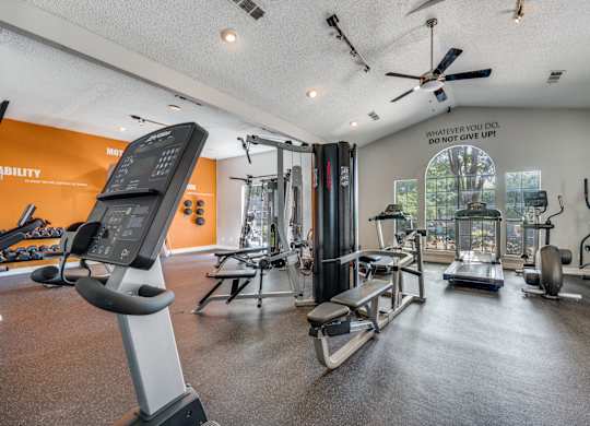 spacious gym with cardio machines and weights at the everyday gardener apartments at Foxborough Apartments, Irving, TX, Texas, 75061