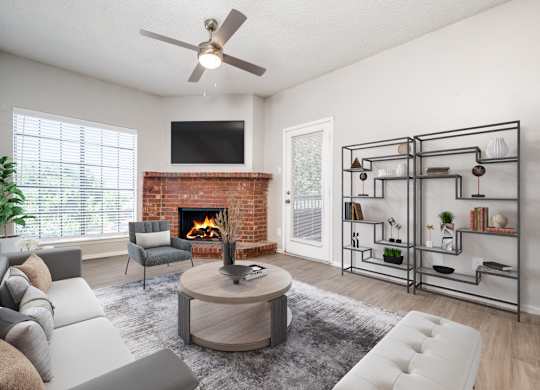 an open living room with a fireplace and a ceiling fan at Foxborough Apartments, Irving, TX, Texas, 75061