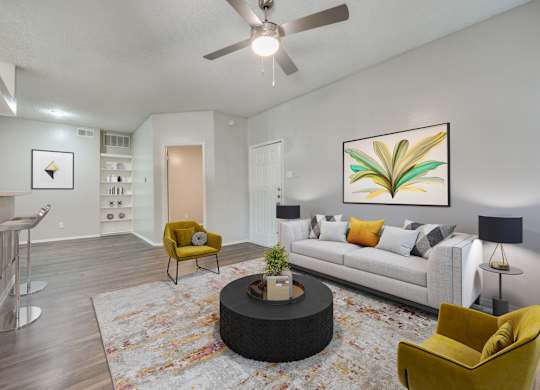 a living room with a couch and a ceiling fan at Foxborough Apartments, Irving, TX, Texas, 75061