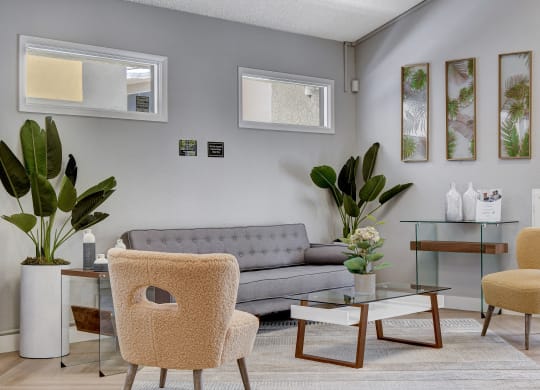 a living room with a gray couch and two yellow chairs at Summer Meadows, Las Vegas, Nevada