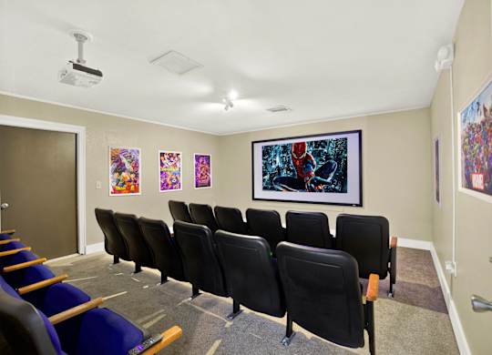 A room with a row of chairs and a painting on the wall.