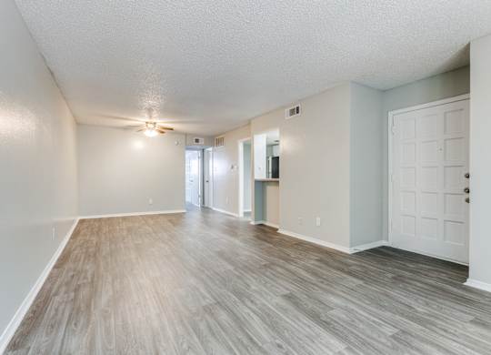 the spacious living room and dining room of an apartment at Falls on Clearwood Apartments, Richardson, TX, Texas