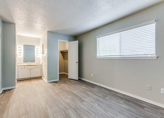 an empty living room with a bathroom and a window at Falls on Clearwood Apartments, Richardson, TX, Texas
