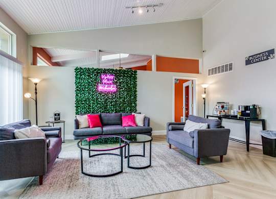 a living room with couches and chairs and a green wall at Falls on Clearwood Apartments, Richardson, TX, Texas