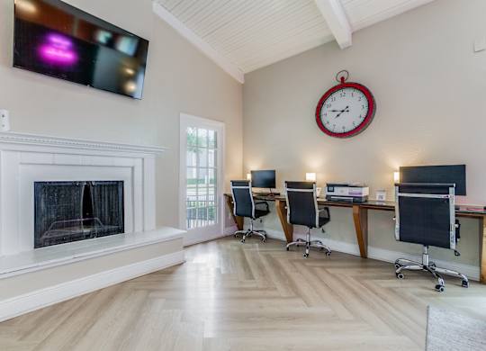 a home office with a fireplace and a clock on the wall at Falls on Clearwood Apartments, Richardson, TX, Texas