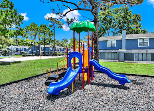 A playground with a blue slide and a green top.
