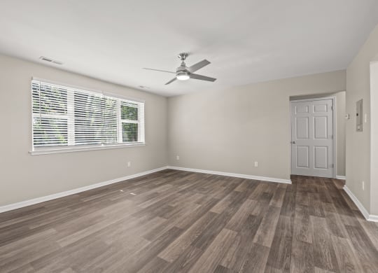 a bedroom with hardwood floors and a ceiling fan at Hampton Gardens, Saint Louis, 63139