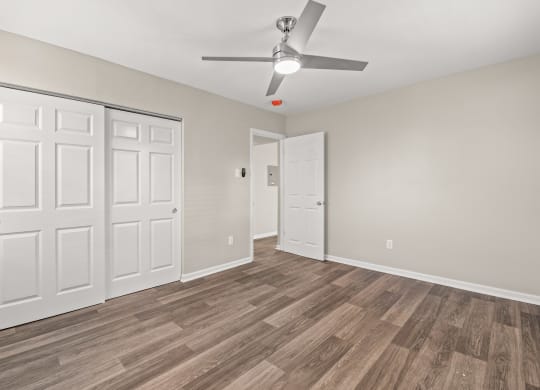 a bedroom with hardwood flooring and a ceiling fan at Hampton Gardens, Saint Louis, Missouri