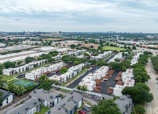 A bird's eye view of a residential area with multiple houses and apartment buildings.