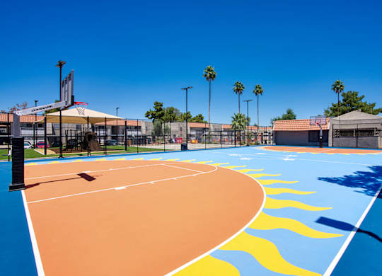 A basketball court with a blue sky in the background.