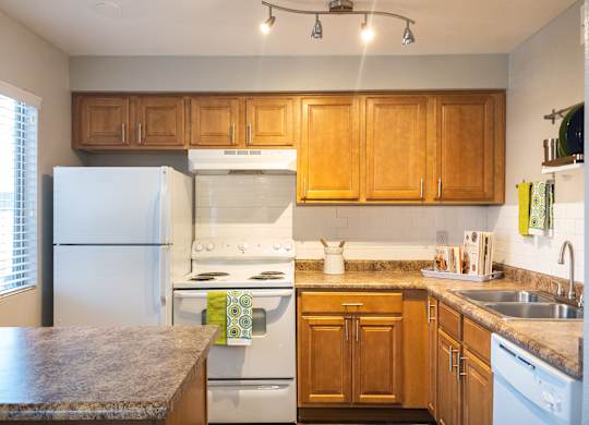 a kitchen with white appliances and wooden cabinets at Granite Bay, Phoenix, Arizona, 85023