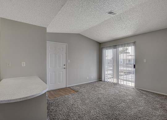 A room with a white door and a window with blinds.