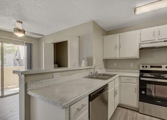 A kitchen with a stove, oven, and cabinets.