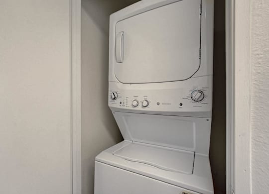 A white washing machine in a small space.