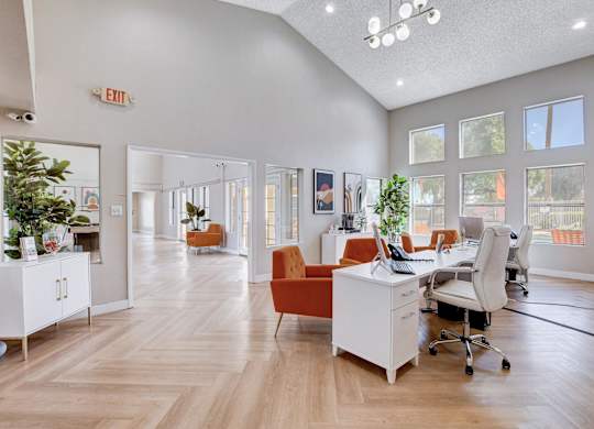A brightly lit office space with wooden floors and white walls.