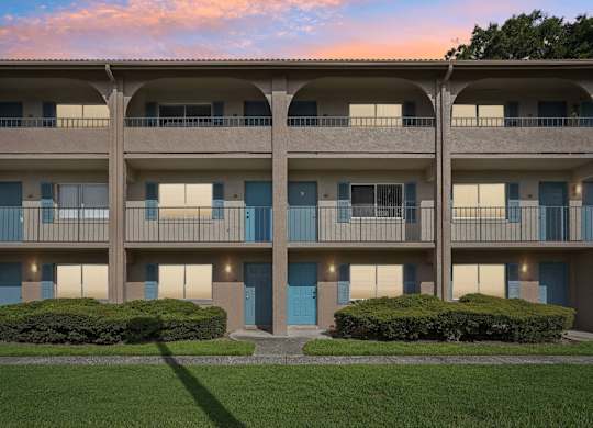 Apartment building with blue doors and windows.