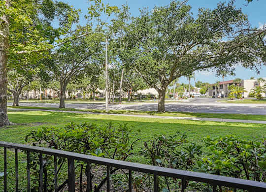 A view of a green lawn from a balcony.